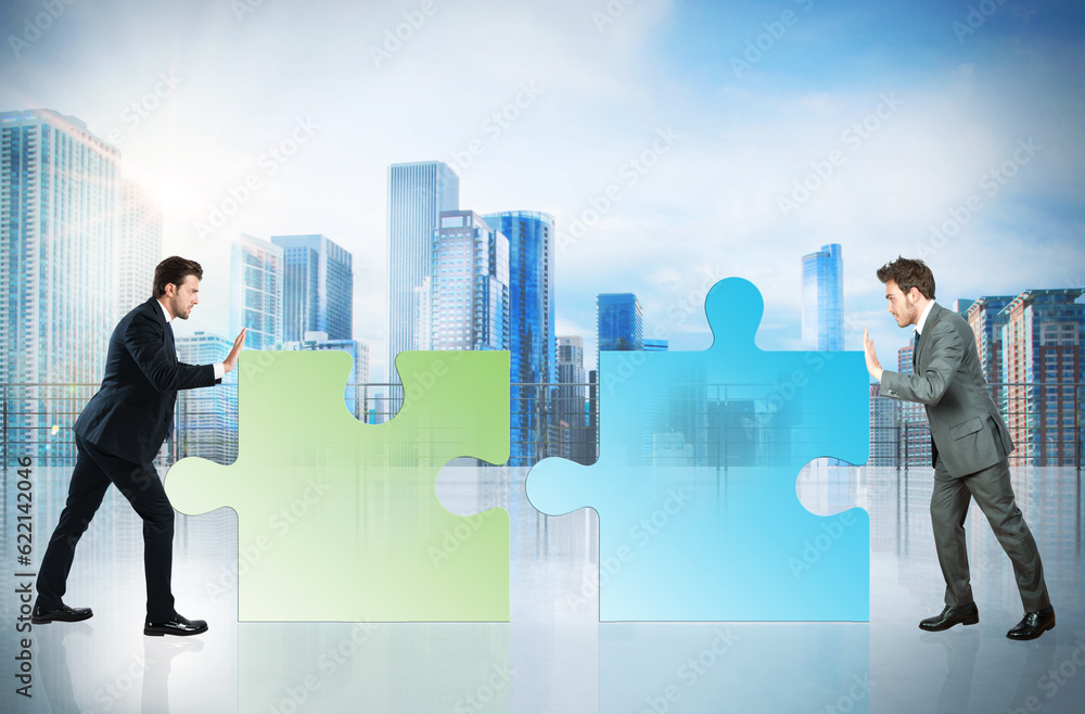 Businessmen push a pieces of puzzle fit together Businessmen push a pieces of puzzle fit together