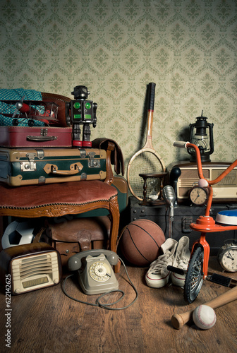 Assorted vintage items in the attic with retro wallpaper background.