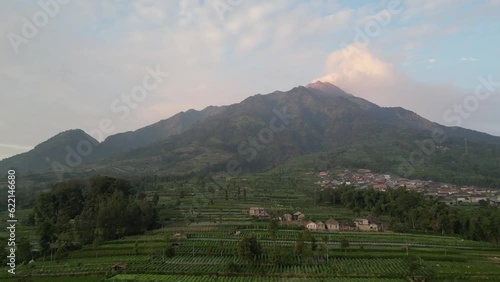 Aerial view of Merapi Volcano mountainside in the morning with vegetable garden and village settlements or housing in Selo Boyolali, Central Java, Indonesia - Straight Movement. photo