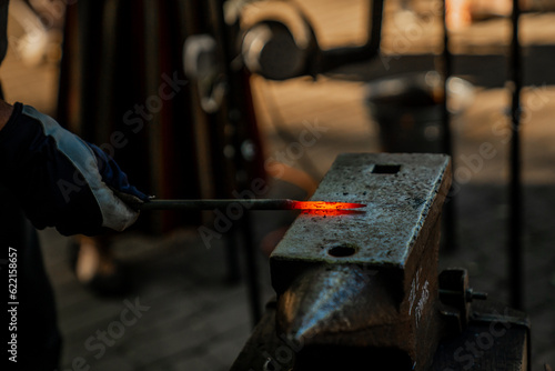 Hammering hot metal in forging process