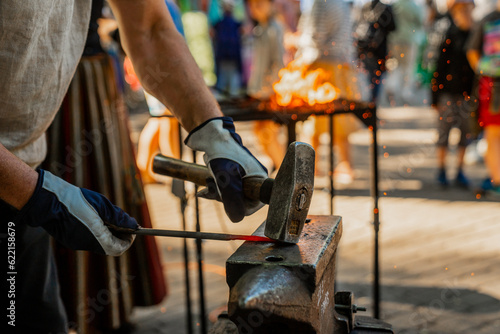 Blacksmith forging metal with fire