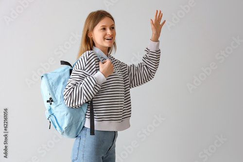 Happy female student with b...
