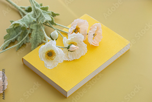 Yellow flowers on top of a book and thank you note