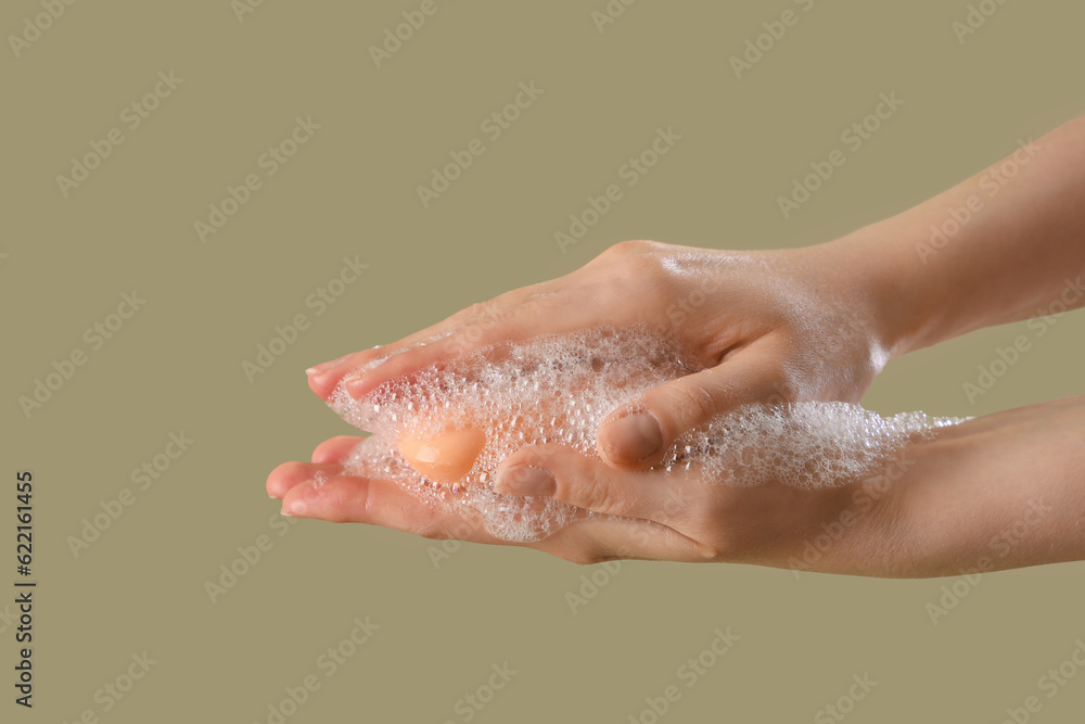 Fototapeta premium Hands with soap on color background