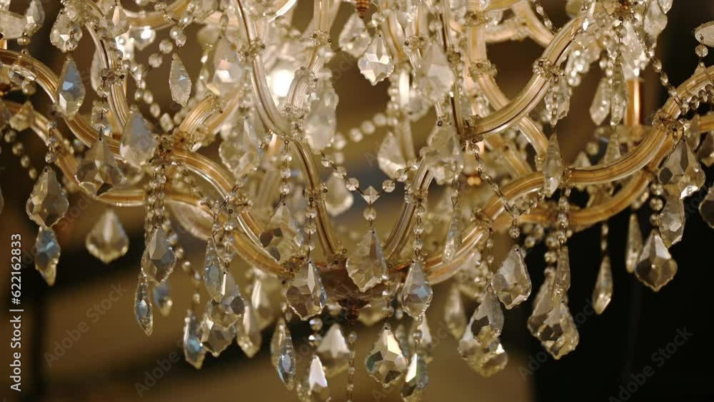 A crystal chandelier with crystals shimmers with bright lights. The ceiling light is brightly reflecting. Volumetric lamp with crystals rotates smoothly. A crystal chandelier with crystals shimmers with bright lights. The ceiling light is brightly reflecting. Volumetric lamp with crystals rotates smoothly.