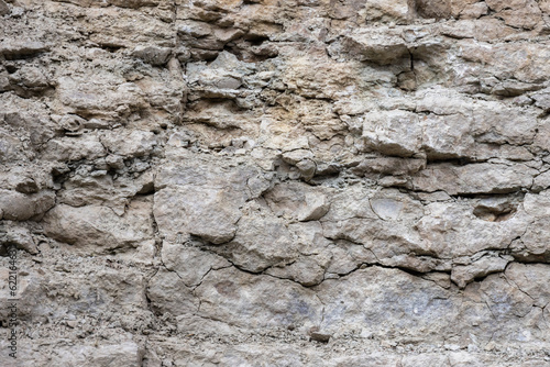 Fotografia Rough rock wall, natural stone background texture