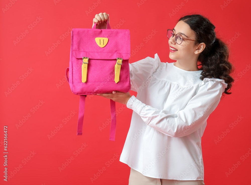 Female student with backpack on red background Female student with backpack on red background