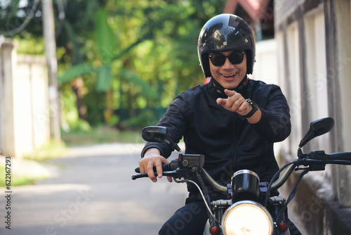 Asian man motorbike in black leather jacket travel rider trip. Handsome Men wear sunglass outdoor lifestyle freedom rider. Men trendy hipster cool person. Young asian man hobby ride with motor bike © aFotostock
