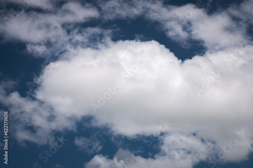 Close-up of a white cloud against a dark blue sky. cloud background