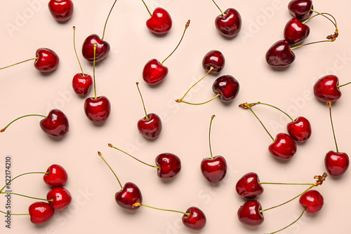 Red sweet cherries on light pink background