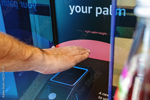 Male hand scanning his palm to pay with modern wireless payment technology