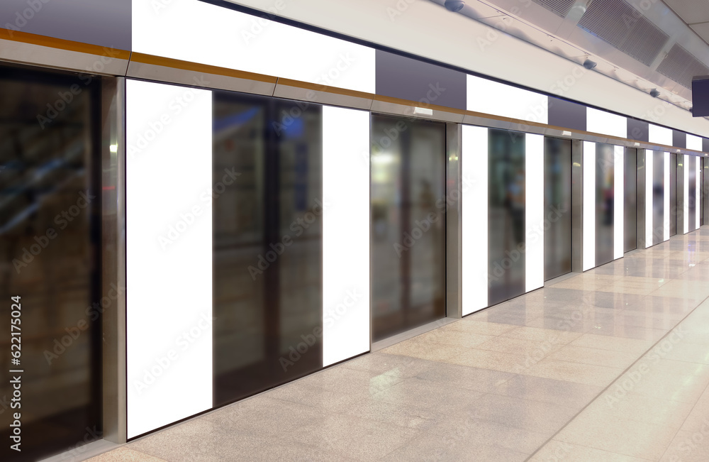 Perspective view of mockup of multiple blank banners, posters, in generic train station; advertising space templates; OOH mock up. Straight front view of MRT platform, without people