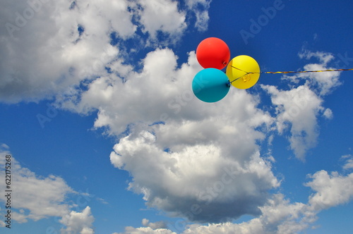 Multicolored helium filled balloons in the sky.