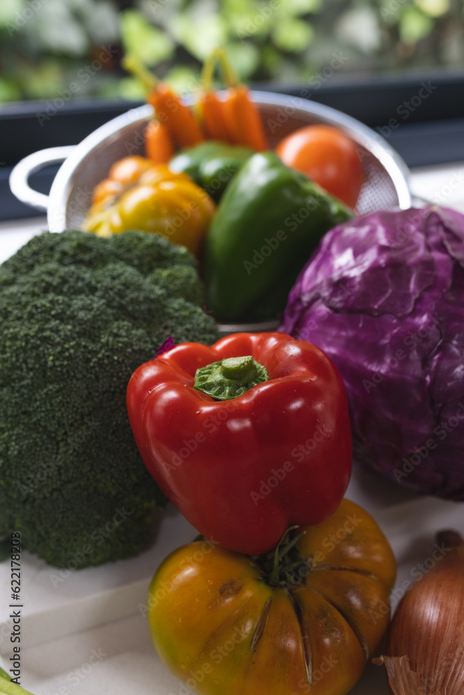 Close up of colourful vegetables on white worktop in kitchen Close up of colourful vegetables on white worktop in kitchen