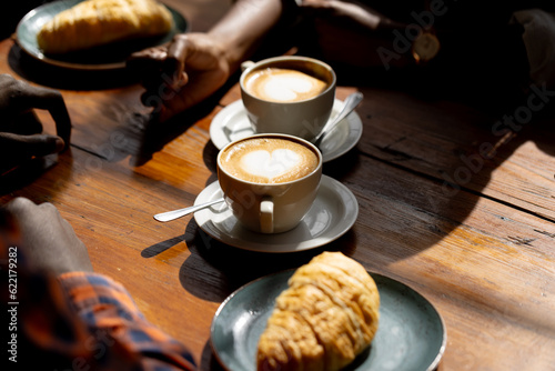 Hands of african american couple sitting at table in a cafe