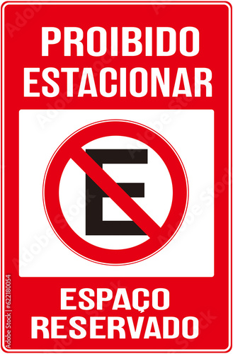 Sign that says in Portuguese languagge : PARKING PROHIBITED - RESERVED SPACE or  no no parking reserved space photo