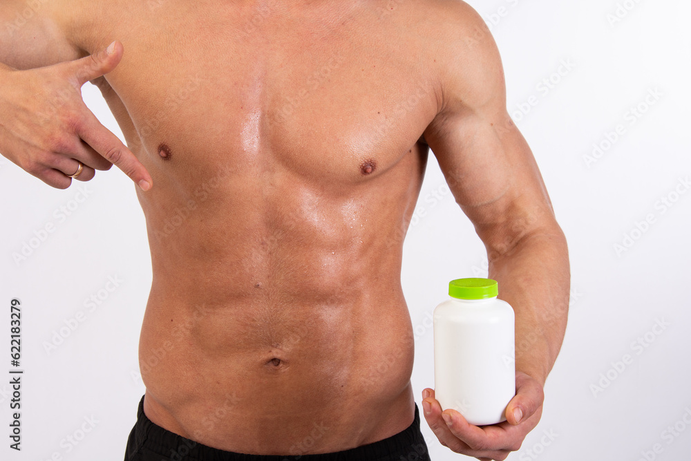 Young attractive sportsman with food supplements. Young attractive sportsman with food supplements.