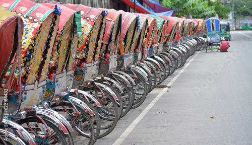 Rickshaws are also popular transport  and a vehicles in whole over Bangladesh. Hundreds of rickshaws parked in the capital city of Dhaka in Bangladesh. photo
