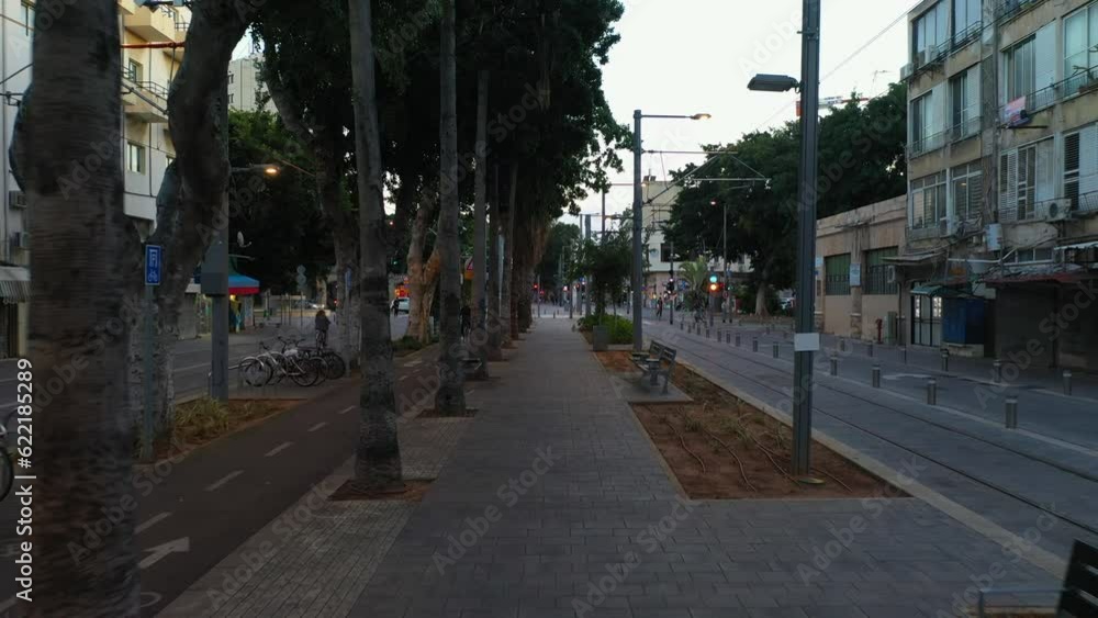 Trees On Footpath Amidst Streets And Buildings In City During Sunset - Tel Aviv, Israel Trees On Footpath Amidst Streets And Buildings In City During Sunset - Tel Aviv, Israel