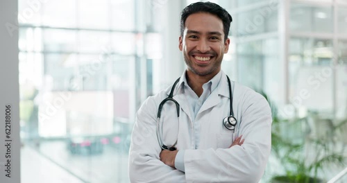 Face, doctor and Asian man with arms crossed, smile and career with success, healthcare and hospital. Portrait, male person and expert medical professional with wellness at clinic and happy employee