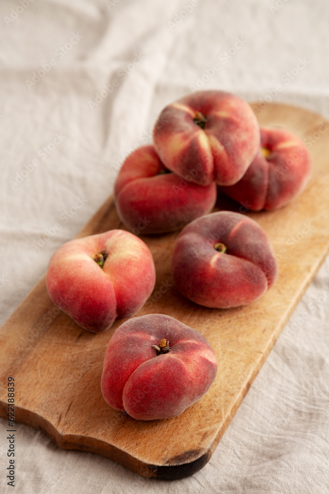 Organic Donut Saturn Peaches on a rustic wooden board, side view. Organic Donut Saturn Peaches on a rustic wooden board, side view.