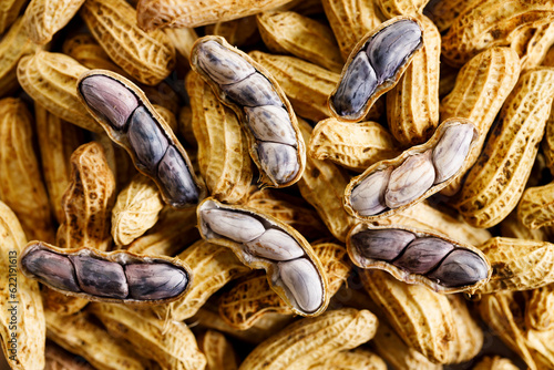 Wallpaper Mural Unpeeled and peeled groundnuts on brown color background. Torontodigital.ca