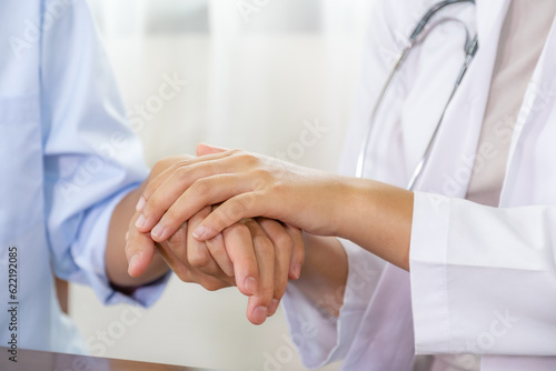 The doctor hands holding patient hand to encourage and explained the health examination results, medical checkup concept