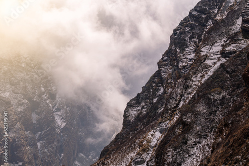 Machhapuchhre Peak, the sunrise area of annapurna base camp, Nepal, is a very beautiful peak of the Himalayas. snow capped peaks photo from a distance The red-orange morning sun shines brightly.