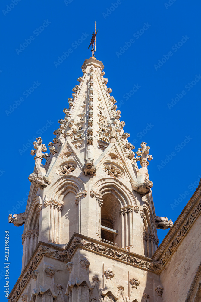 Stone steeple of Gothic cathedral against sky 