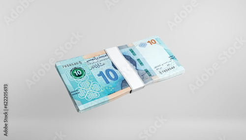 Obraz na płótnie A stack of ten tunisian dinars cash bills on a white neutral background