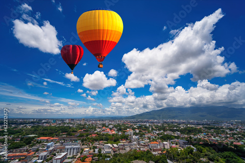 Hot air Balloon flying over the City, Landscape with hot air balloons flying over Chiang Mai City in a day of many clouds in the sky, Thailand, Asia