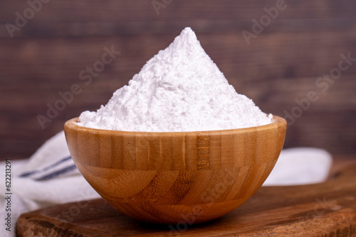 Wheat starch on wood background. Wheat starch in wooden bowl. close up