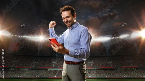 Fotografi Positive, happy, emotional businessman holding mobile phone and celebrating money win