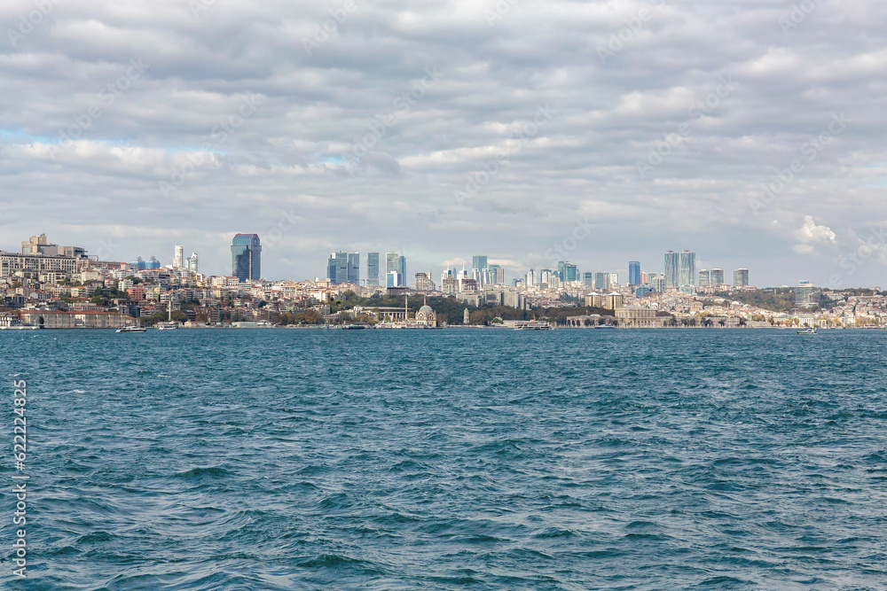 Istanbul panorama as seen from Bosphorus and Kadikoy. Sunny october day, beautiful clouds, Sisli towers at skyline. Istanbul, Turkey