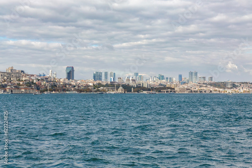 Istanbul panorama as seen from Bosphorus and Kadikoy. Sunny october day, beautiful clouds, Sisli towers at skyline. Istanbul, Turkey