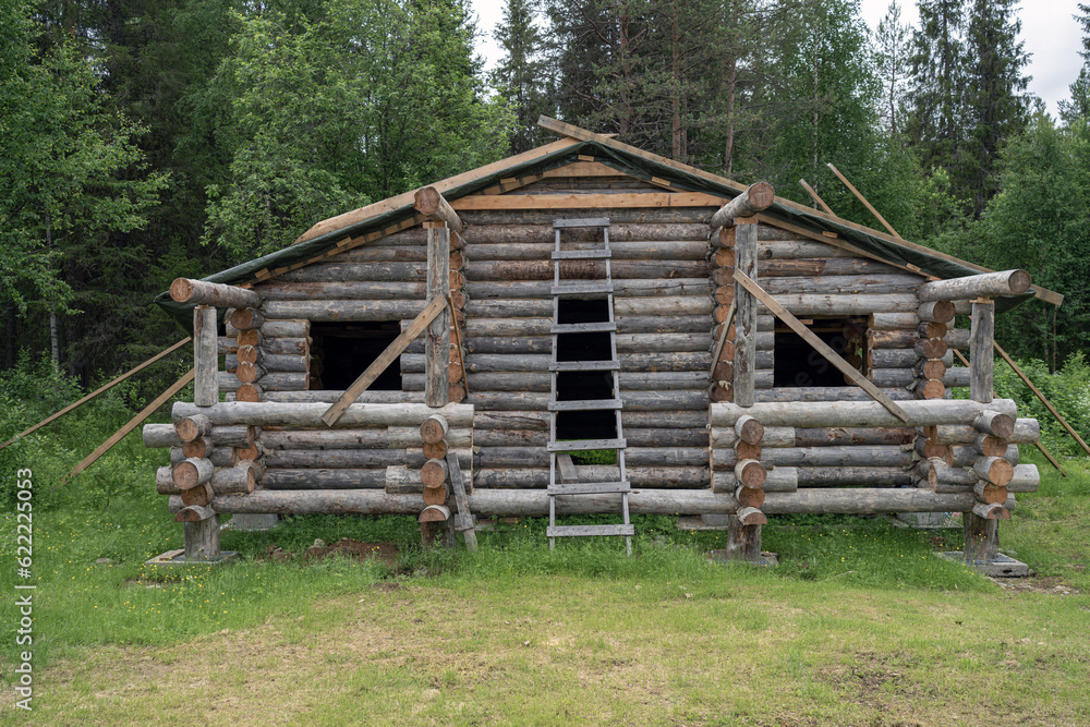 Construction site of wooden mountain house. Traditional log cabin built from wood logs.. Cottage house design. Construction site of wooden mountain house. Traditional log cabin built from wood logs.. Cottage house design.