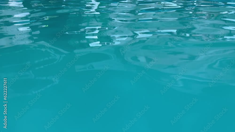 The texture of the turquoise water surface with little reflection. The texture of the turquoise water surface with little reflection.