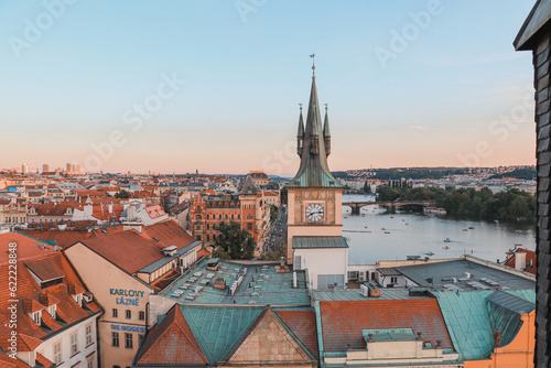 Old Town of Prague under the warm rays of the setting sun illuminating the rooftops of historic buildings in the capital of the Czech Republic. The centre of Prague