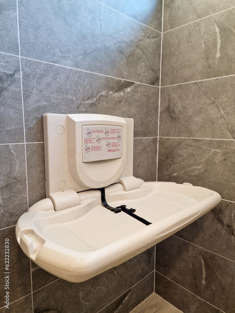 Baby nappy diaper changing table in a public toilet restroom. Child