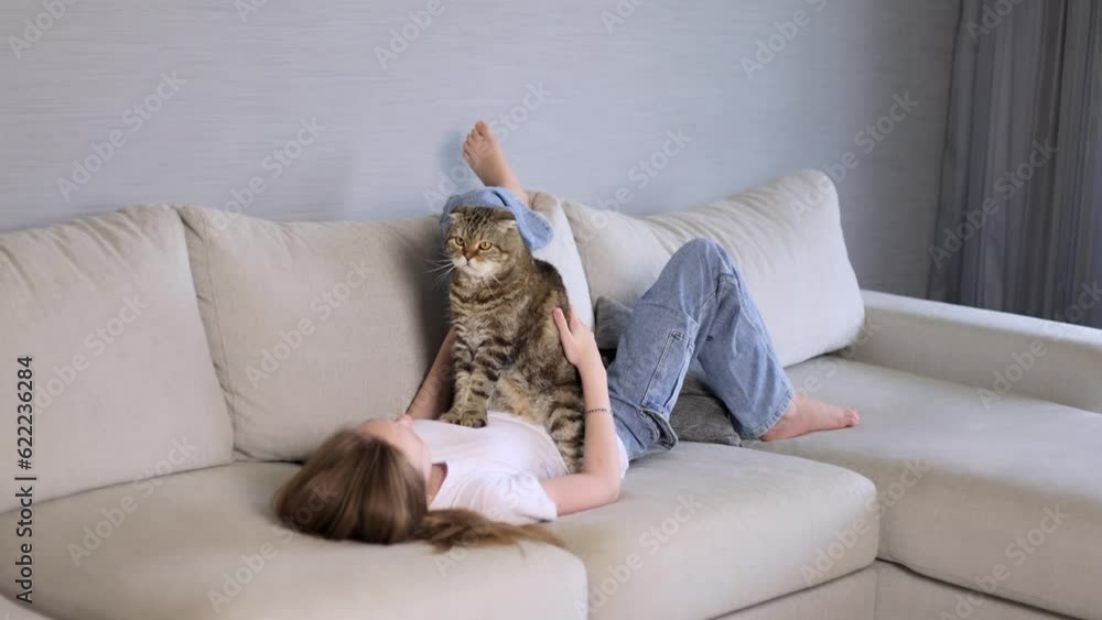 Girl with her pet on the couch.