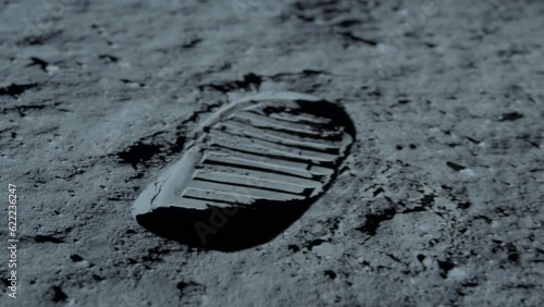 Lunar astronaut walking on the moon's surface and leaves a footprint in the lunar soil. 3d rendering. Some Elements of this video furnished by NASA.