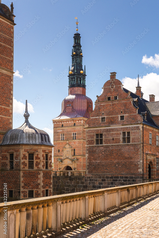 Obraz premium Summer, sunny and warm view of Hillerod Castle in Denmark. There is a beautiful garden around the castle and it is worth visiting this place while in this area.