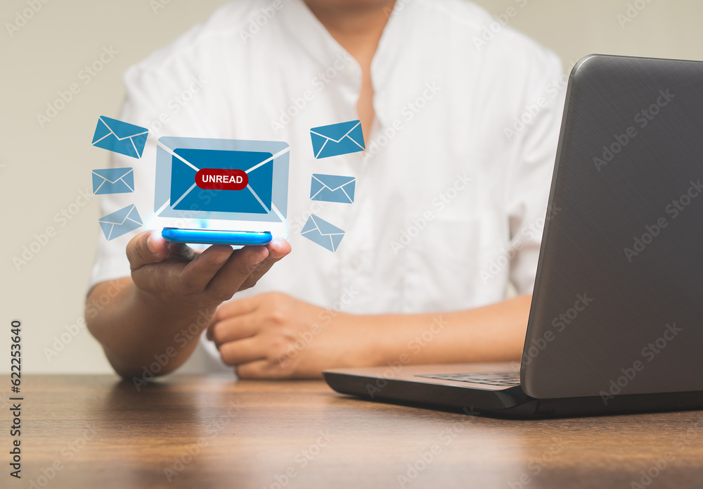 Business people using a mobile receive a new message with email icons while sitting at the table. Business people using a mobile receive a new message with email icons while sitting at the table.