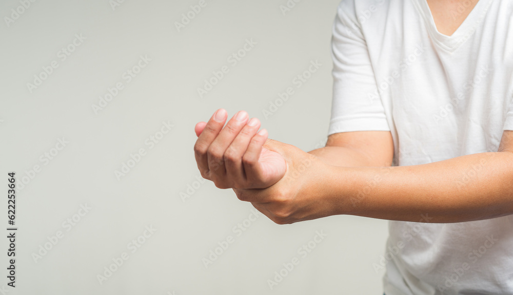 Closeup of hands suffering from wrist pain. Causes of hand shaking