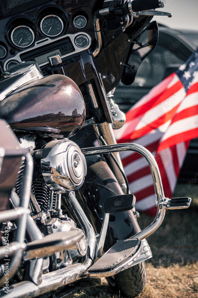 Close-up of a motorcycle with american flag on the background Close-up of a motorcycle with american flag on the background