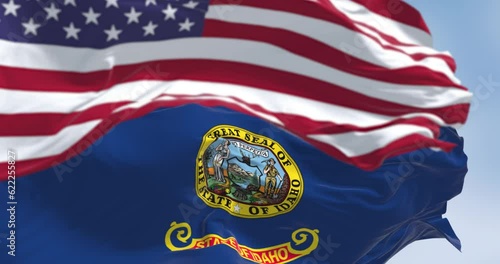 Wallpaper Mural Idaho state flag waving with the national flag of the US blurred in the foreground Torontodigital.ca