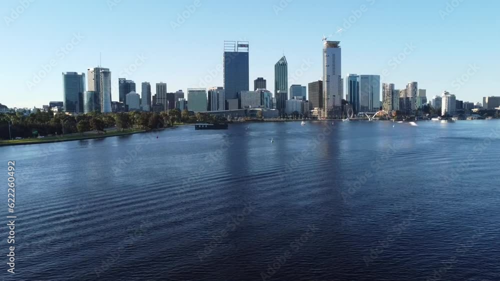 Drone shot descending down to sanding beach bank of Swan River with skyline of Perth, Western Australia from and South Perth foreshore Drone shot descending down to sanding beach bank of Swan River with skyline of Perth, Western Australia from and South Perth foreshore