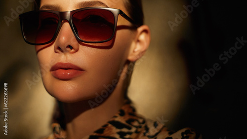  Classic sunglasses fashion. Beautiful youg woman wear shirt with a leopard print and classy square shape brown eye glasses. Summer accessory. © Beauty Agent Studio