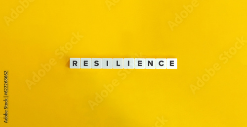 Resilience Word on Block Letter Tiles on Yellow Background. Minimal Aesthetic.