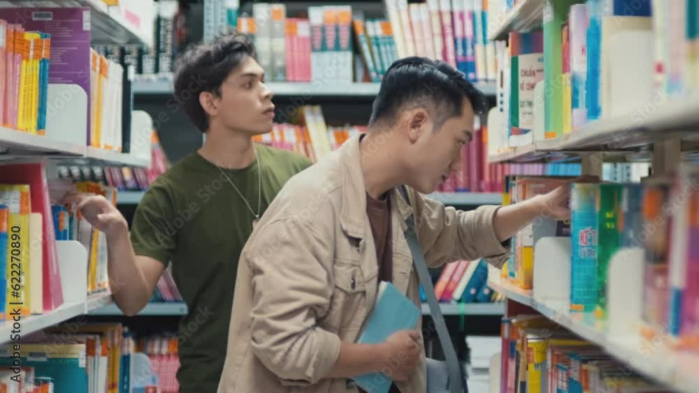 Medium shot of college students searching for book to prepare for exam Medium shot of college students searching for book to prepare for exam